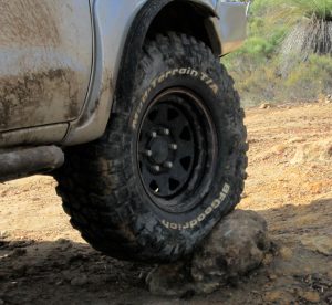 BF Goodrich Mud Terrain tire deforming around rock.